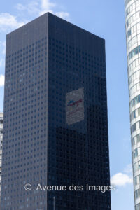 Reflection of a logo in a black glass tower