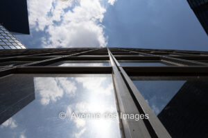 Looking vertically up a glass tower building in La Défense