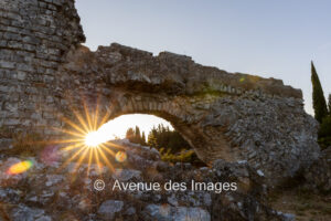 Roman aqueduct de Barbegal at sunset with the sun shining through he arches