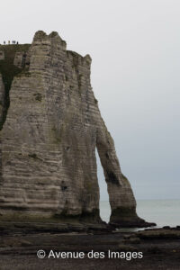 Falaise d'Aval Etretat from the beach with people to give scale