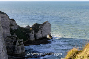 La Falaise d'Amont with the sun shining through the arch Etretat, Normandy France